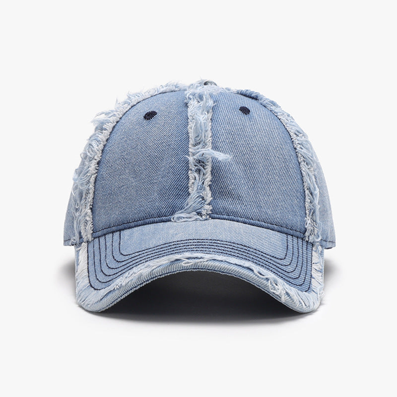 Gorra de béisbol de algodón desgastada en tonos azules con detalles de costura y roturas